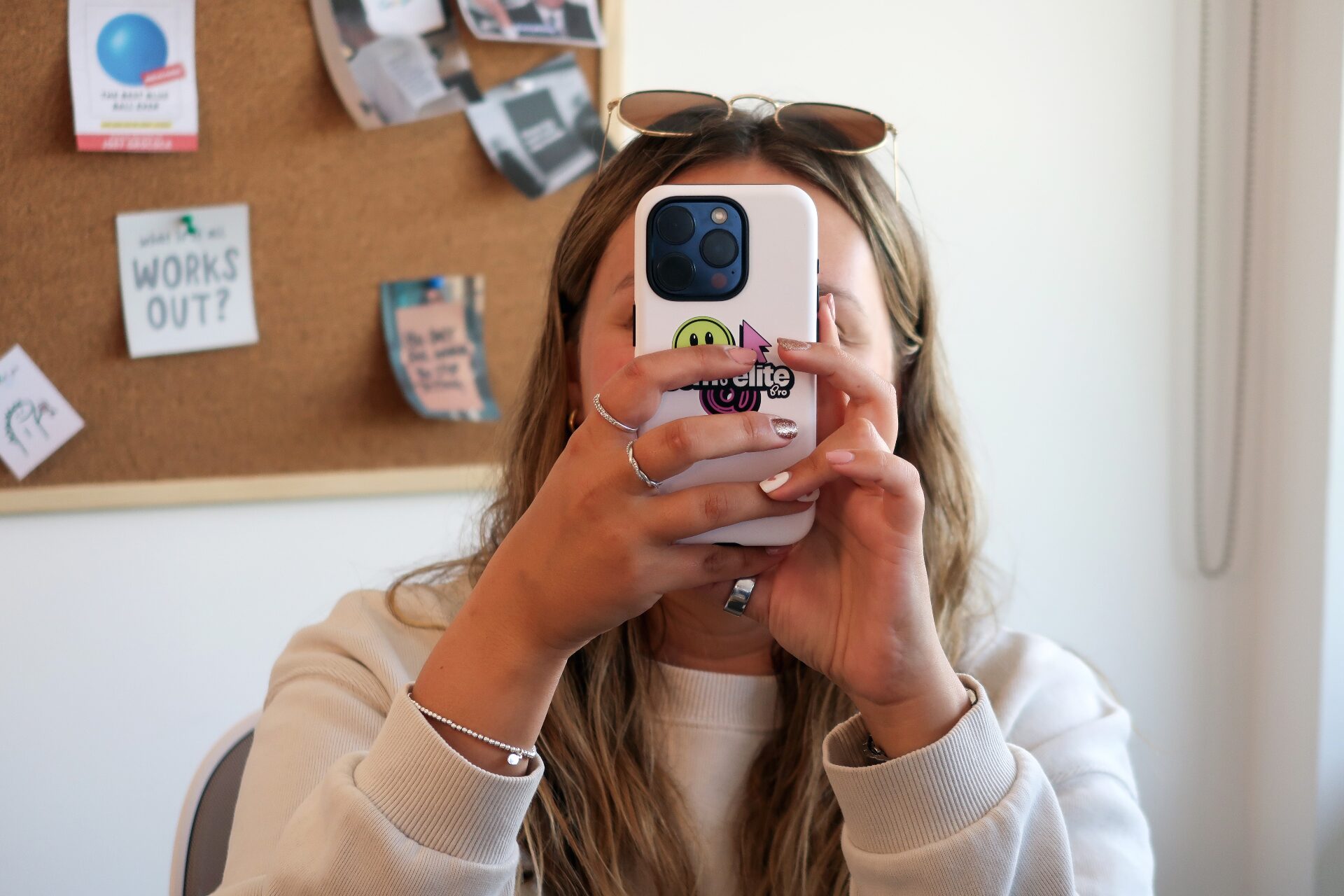 Compelite Pro team member with branded phone case taking a photo