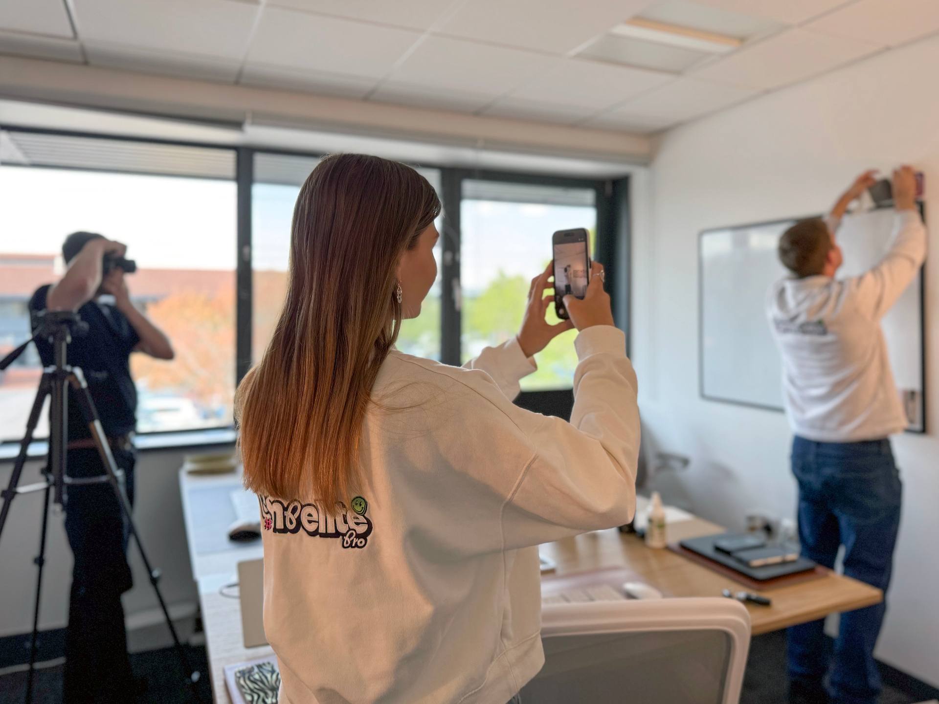 Compelite Pro photographer shooting a client team in branded hi-vis vests outside a Georgian manor — half-day content shoot in action