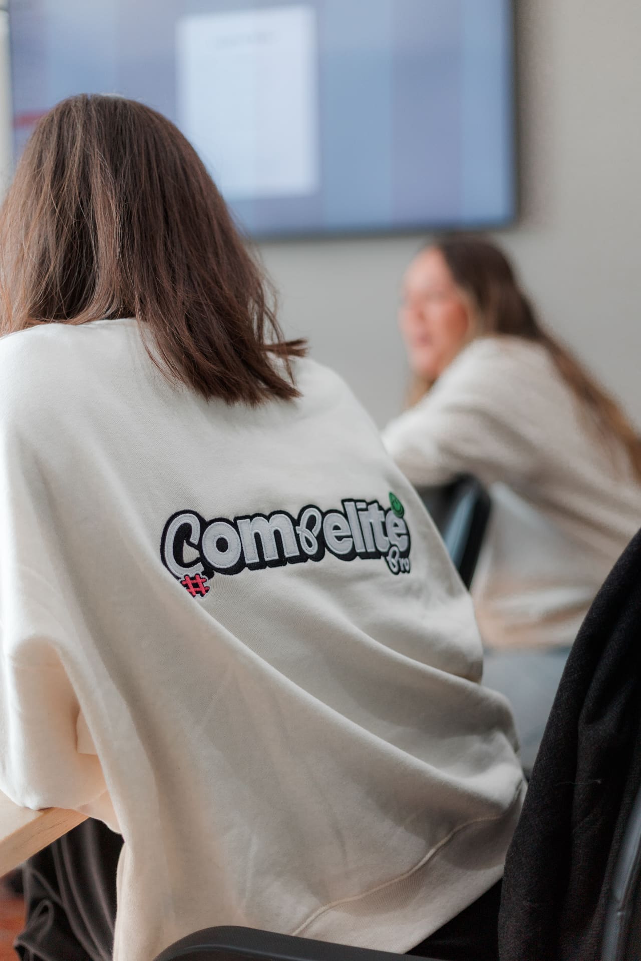 Compelite Pro team member in branded sweatshirt at work